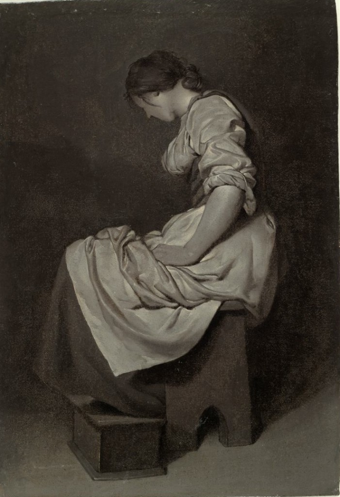 A young woman seated and wearing a white dress.