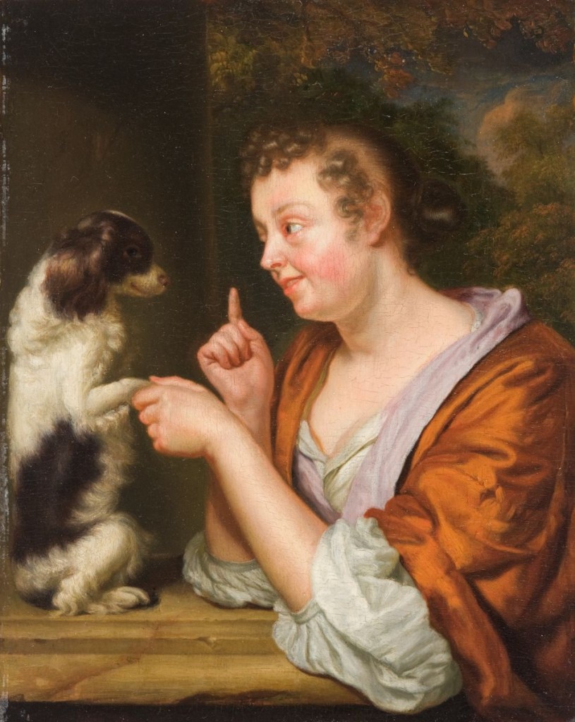 Portrait of a woman dressed in orange with her black and white dog.