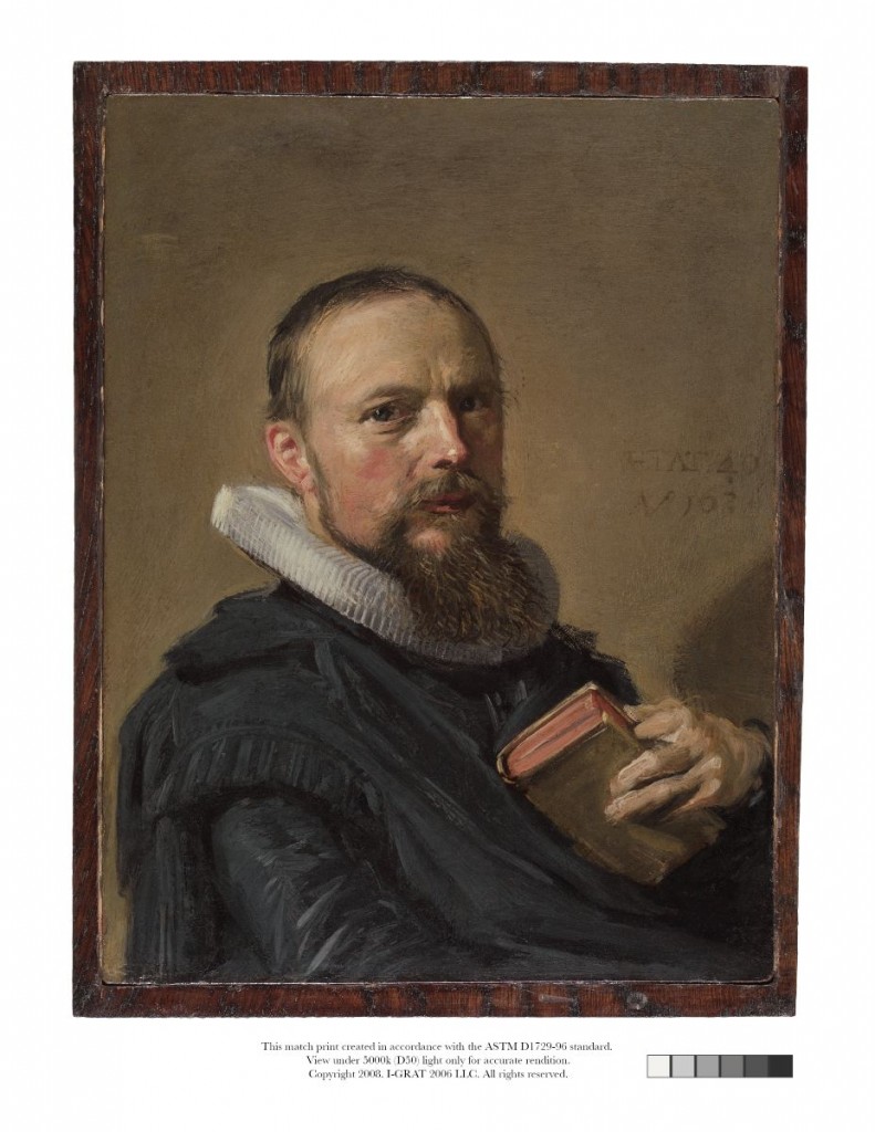 Portrait of an older man with a beard. He wears blue clothing and holds a book.