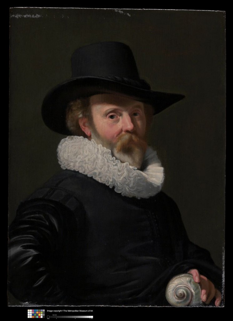 Portrait of a man wearing a black hat and a black shirt with a thick white collar. He has a thick beard, and holds a seashell.