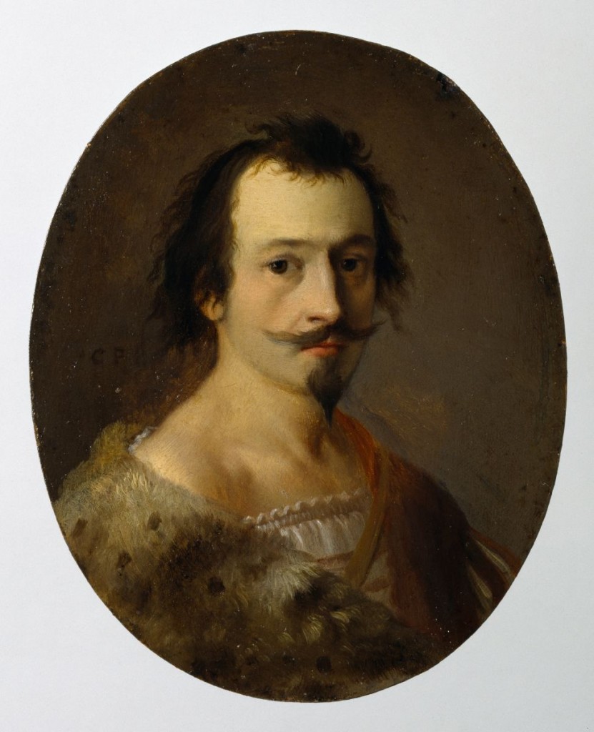 Portrait of a young man with facial hair wearing fur.